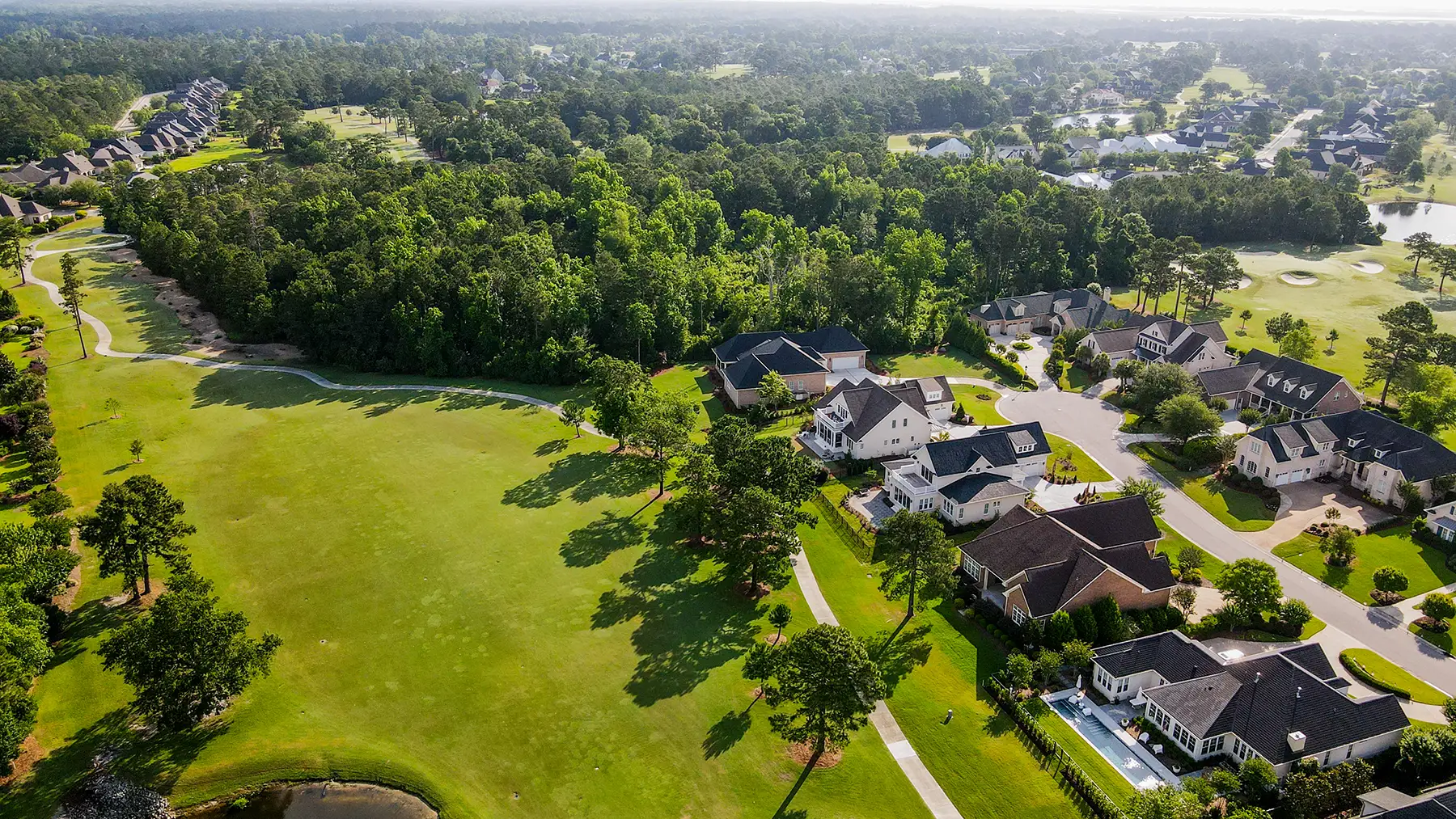 Landfall homes beside a tree-lined golf fairway