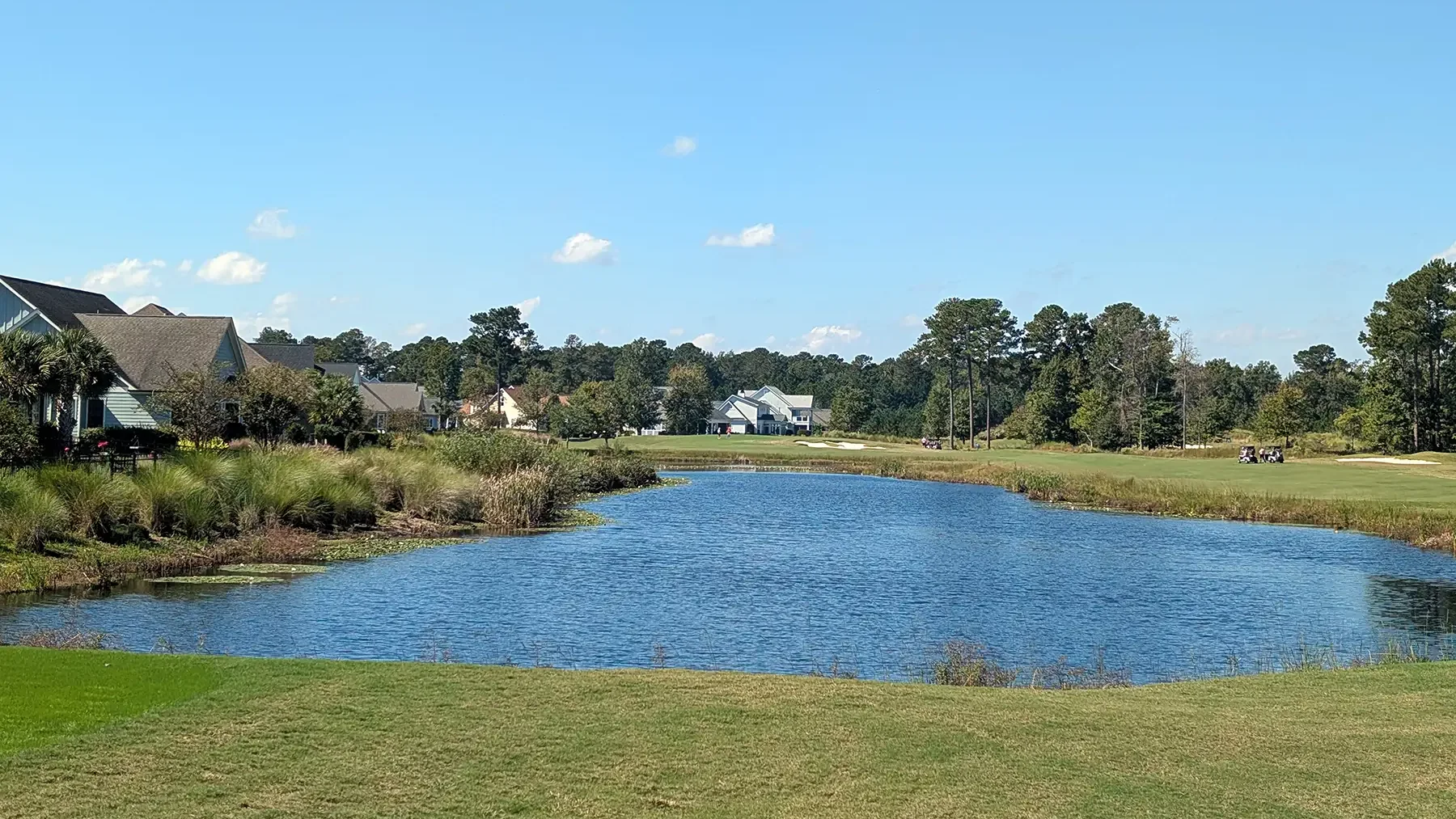 Pond beside a fairway with homes along the far bank in Brunswick Forest, Leland, NC