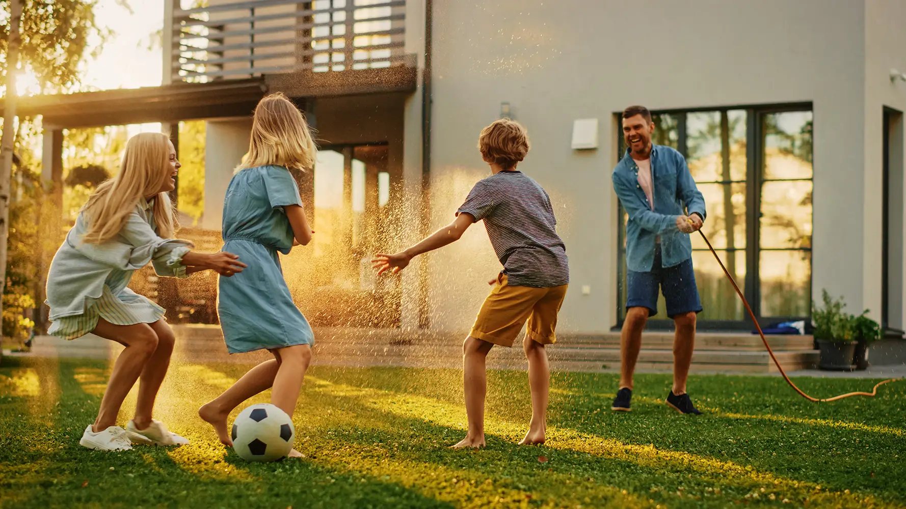 A family playing together in a sunny backyard