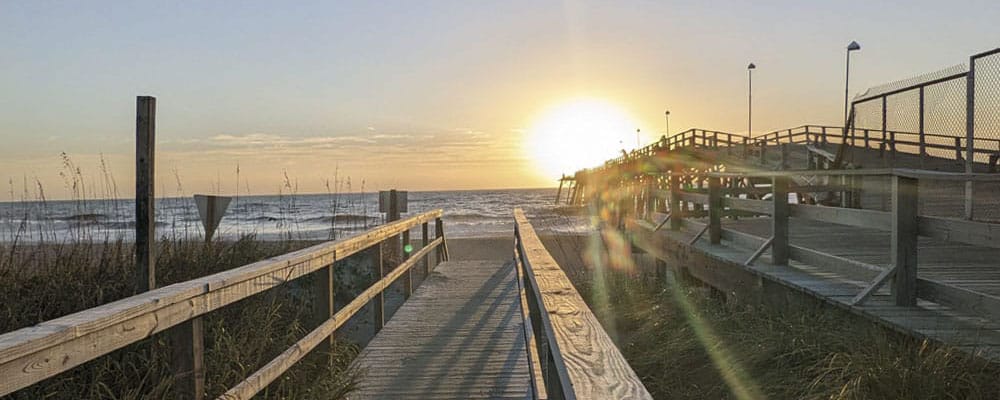 Beach access ramp beside the pier at sunrise